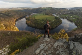 Man standing on a rock at sunset on spring evening at the loop of the Vltava (Vltava) View Solenice