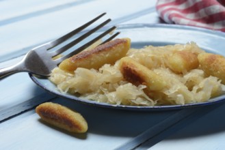 Fried puff noodles with sauerkraut on plate