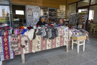 Two woman selling colorful hand-knitted clothes at a market stall, Noratus, Noradus, Gegharkunik