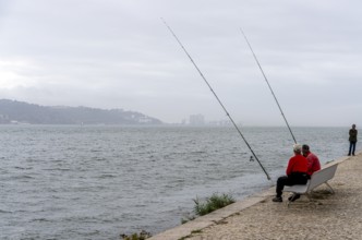 Anglers on Ponte 25 de Abril, 3.2 km long bridge in Portugal with a 2278 meter long suspension
