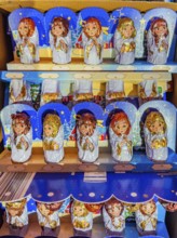 Chocolate Christmas angel in musical instruments printed on colorful staniol paper on a retail