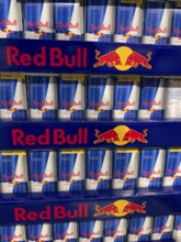 Red Bull soft drink in stacked aluminum cans aluminum cans at retail grocer, Germany