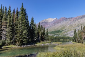 240831_301 Rugged Mountains rise up behind the south end of Swiftcurrent lake in Glacier National