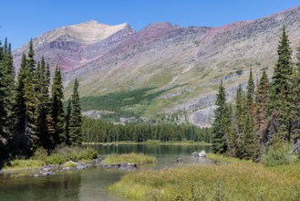 240831_300 Rugged Mountains rise up behind the south end of Swiftcurrent lake in Glacier National