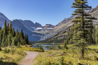 240831_277 Couple canoing on Josephine Lake surrounded by the rugged mountains of Glacier National