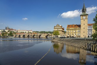 Vltava embankment with Old Town Water Tower, Novotný Bridge and Charles Bridge in Prague, Czech