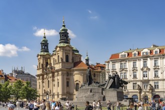 The Baroque St. Nicholas Church and the Jan Hus Memorial on Old Town Square in Prague, Czech