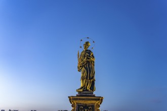 Saint John Nepomuk on Charles Bridge at dusk, Prague, Czech Republic