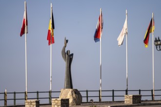 Stylized Prometheus sculpture and flag gallery in modern Delphi, Greece