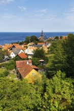 View of Gudhjem, view over the roofs and the church to the Baltic Sea with Christiansø, Christiansö