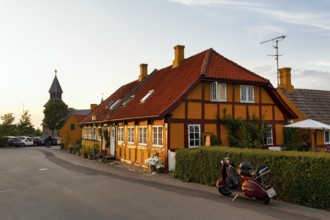 Characteristic half-timbered houses, street scene with church tower, Gudhjem, Bornholm, Baltic Sea,