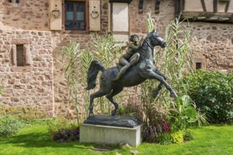 Statue of a woman riding with horse La Dame du Parc in Riquewihr