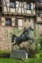 Statue of a woman riding with horse La Dame du Parc in Riquewihr