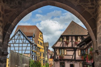 Decorated half-timbered houses at the entrance to the historic old town of Riquewihr, Ellsass