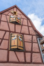 Timbered house with storks as decoration in Riquewihr, Alsace