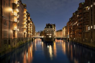 Night view, historic moated castle, warehouses, brick buildings, canal, Hamburger Speicherstadt,