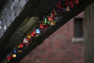 Colourful, colorful love locks hang on a bridge, warehouses, brick buildings, Hamburger