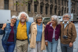 Smiling group of diverse senior friends standing close, showing togetherness and happiness while