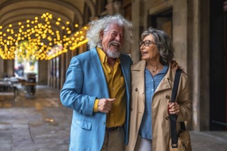 Senior couple strolling arm in arm through an arched city passage, smiling and laughing under