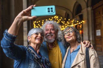 Three happy senior friends enjoying a city trip, smiling and embracing while taking a joyful selfie