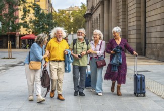 Happy group of five older friends traveling and walking arm in arm through a european city,