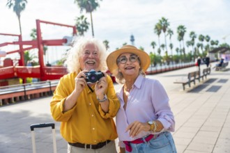 Happy senior couple enjoying their vacation and exploring a sunny city while traveling, capturing