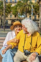 Smiling senior woman embracing her husband on a bench, having a happy moment during their exciting