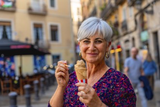 Senior woman smiling while enjoying an ice cream cone on a sunny european city street, relaxed and