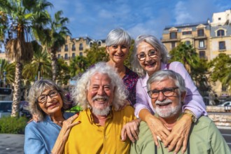 Happy multiracial senior friends smiling and embracing on a sunny city street during vacation,