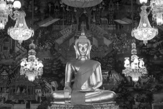 Golden Buddha statue, Phra Buddha Trilokachet surrounded by crystal chandeliers and exquisite wall