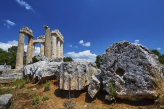 Large stones and ancient pillar remains under bright blue sky, Nemea, Ancient Zeus Heightum,