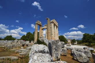 Ancient remains and columns surrounded by large stones under a cloudless sky, Nemea, Ancient Zeus