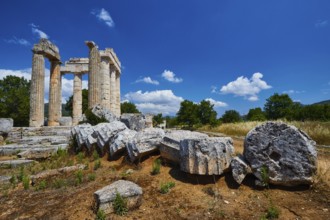 Stone columns and fragments against a clear blue sky in an open landscape, Nemea, Ancient Zeus