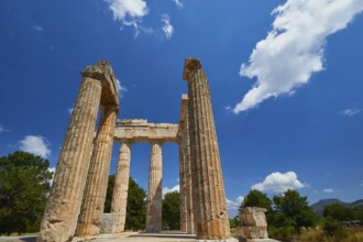 Pillars of an ancient structure under a clear sky with few clouds, Nemea, Ancient Zeus Heightum,