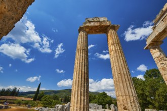 Ancient ruins stand imposing against a clear blue sky with some clouds, Nemea, Ancient Zeus Church,