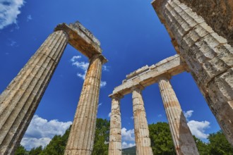 Ancient columns rising against a blue sky, Nemea, Ancient Zeus Heightum, Archaeological Site,