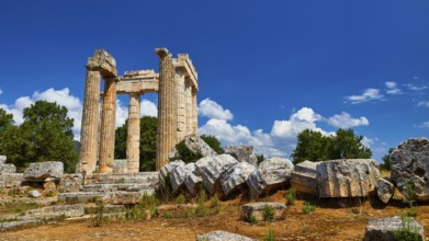 Ancient columns and ruins with loosely scattered stones in the foreground, Nemea, Ancient Zeus