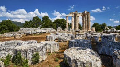 Stone ruins with ancient columns against a blue sky and clouds, Nemea, Ancient Zeus Heightum,