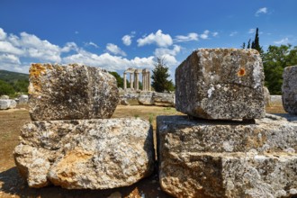 Ancient ruins with large stones against a bright blue sky with clouds, Nemea, Ancient Zeus Church,