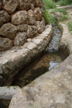 Small trickle on a laying stone wall, Majorca, Spain