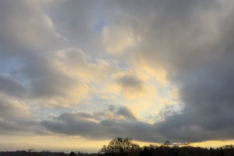 Sky over forest edge at dusk in the middle of clouds Cumulus fractus right and below gray