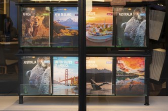 Trailfinders travel agency window display posters, Exeter city centre, Devon, England, UK