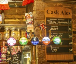 Keg beer taps and labels of different brands inside The Ship pub, Exeter, Devon, England, UK - cask