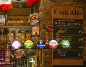 Cask ale menu of different brands inside the Ship pub, Exeter, Devon, England, UK - keg beer taps