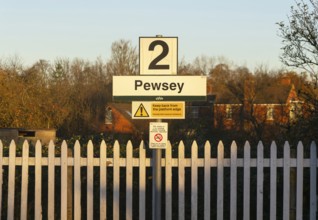 Platform 2 sign in winter morning sunshine, Pewsey railway station, Wiltshire, England, UK