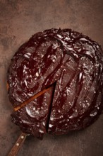 Chocolate cake, round cake, on a brown background, top view, homemade cakes, no people