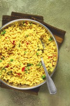 Rice with saffron and vegetables, in a frying pan, top view, homemade, no people
