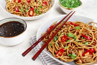 Udon noodles, with shimeji mushrooms, vegetables, in sauce, with sesame seeds, green onions, Asian