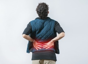 Person with spine problems. Man with pain holding his back. Lumbar problems. Suffering male with