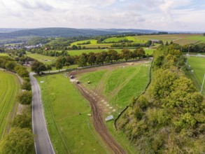 Extensive green landscape with roads and trees under a cloudy sky, Bau PV Freifaechenanlage, Weil